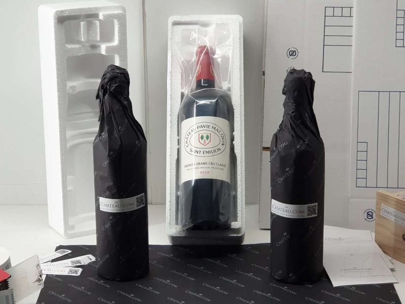 Bottles wrapped in tissue paper or in a protective pouch before being placed in a protective polystyrene